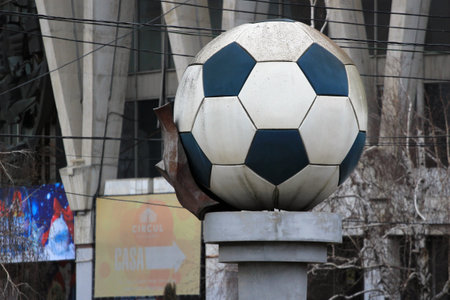 Chisinau, Moldova - December 17, 2017: Monument to soccer ball near the abandoned building of Chisinau circus.のeditorial素材