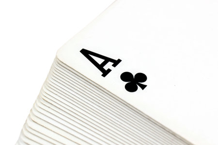 Full deck of playing cards with ace of clubs on top, isolated on white background