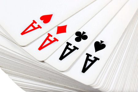 Full deck of playing cards with four aces on top, isolated on white background