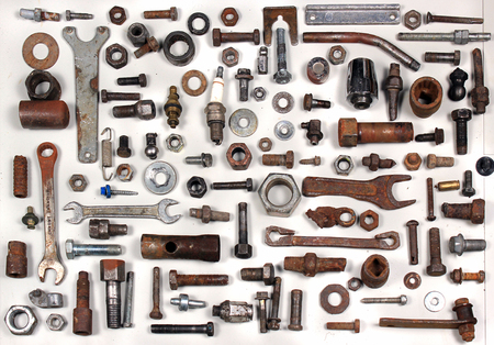 Old rusty bolts nuts and mechanical parts on white backgroundの写真素材