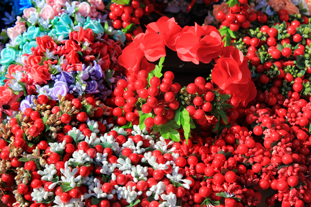 Artificial flowers with decorative beads and bracelets at street marketの写真素材