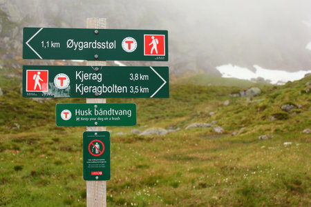 Lysebotn, Norway - June 12, 2018: Signpost showing direction and distance to Kjeragbolten, a boulder wedged in the mountain's crevasse on the mountain Kjerag and a popular tourist destination.のeditorial素材