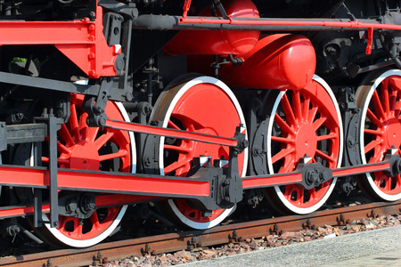 Red painted wheels of a steam locomotiveの写真素材