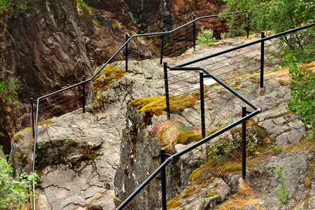 Metal railings at the cliff edge near Dorgefoss waterfall, Norwayの写真素材