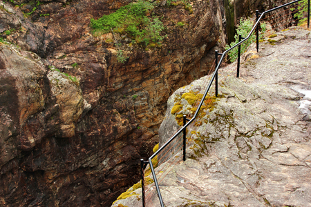 Metal railings at the cliff edge near Dorgefoss waterfall, Norwayの写真素材