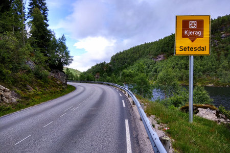 Setesdal, Norway - June 12, 2018: Road sign showing direction to Kjeragbolten, a boulder wedged in the mountain's crevasse on the mountain Kjerag and a popular tourist destination.のeditorial素材