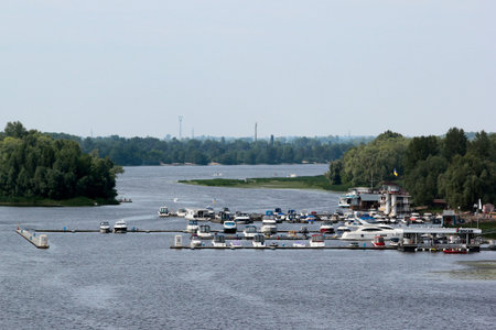 Kyiv, Ukraine - June 29, 2018: Yachts and motor boats in a harbor with moorings on Dnieper river in central Kiev.のeditorial素材