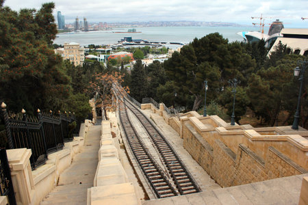 Baku, Azerbaijan - April 25, 2017: New funicular in center of Baku, near the Martyrs' Mosque and Flame Towers skyscrapers.のeditorial素材