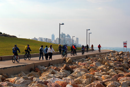 Tel Aviv, Israel - December 7, 2013: People cycle, jog and relax in the Midron Yaffo seafront park, a popular place for recreation among locals and tourists.のeditorial素材