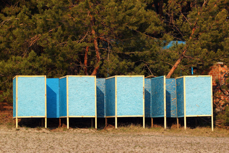 Old cabanas on a beach against forest backgroundの写真素材