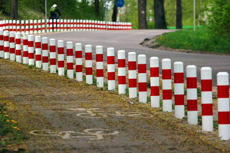 Striped red and white roadside safety postsの写真素材