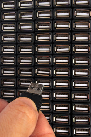 Man inserts USB flash drive in one of many sockets