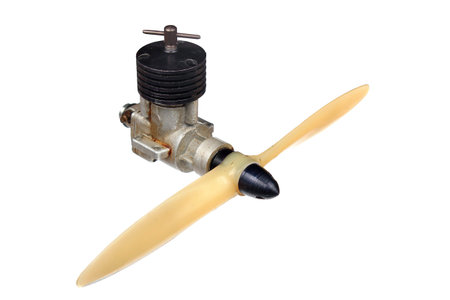 Small aircraft model diesel engine with propeller, isolated against white background