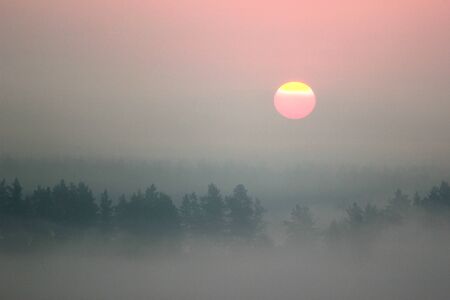 Red morning sun, foggy sunriseの写真素材