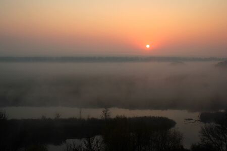 Red morning sun, foggy sunriseの写真素材