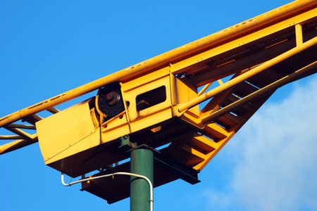 Roller coaster mechanism against blue sky background. Amusement park attractions.