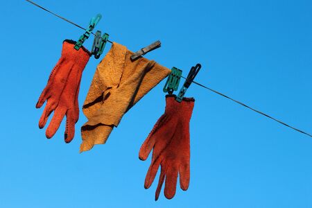 Duster with pegs on a clothesline against blue sky backgroundの写真素材