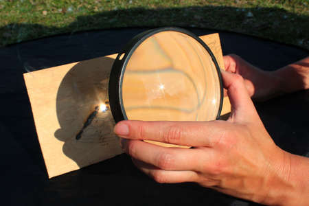 Sunlight burns wood, having passed through the magnifying glassの写真素材