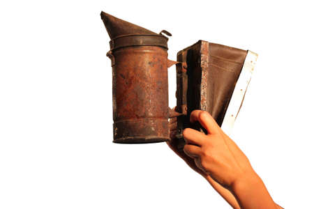 Old bee smoker, a device used in beekeeping to calm honey bees. Isolated against white background.の写真素材