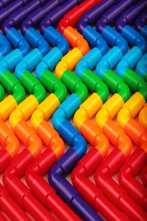 Rainbow colored plastic pipes as backgroundの写真素材