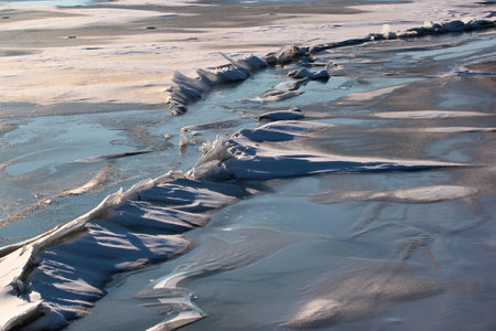Ice and snow on the surface of a frozen lakeの写真素材