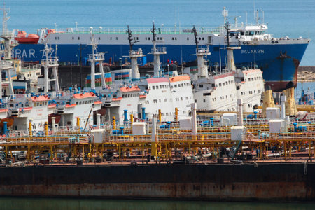 Baku, Azerbaijan - April 27, 2017: Old dry cargo barges and bulk oil carriers at Baku sea port, the large hub on Caspian sea coast.のeditorial素材