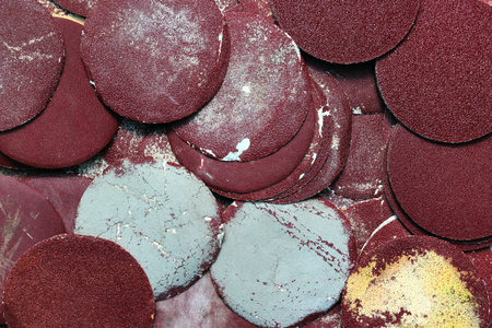Old used orbital sanding discs as carpentry backgroundの写真素材
