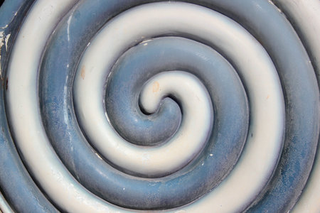 Plastic grey and white lollypop, toy confectionery texture background