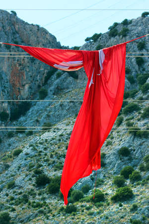 Hanging Turkish flag, tangled by the windの写真素材