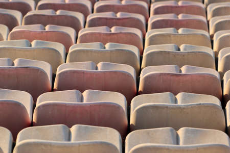Rows of white plastic seats at a stadiumの写真素材