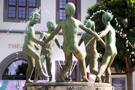 Zwickau, Germany - July 21, 2023: Sculpture of dancing children in a fountain in front of the theater on central Market Squareのeditorial素材