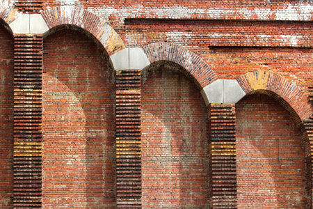 Old red brick wall with protruding columns as backgroundの写真素材