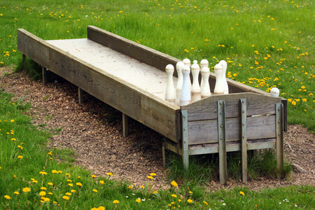 Plastic skittles on a green lawn, outdoor bowling game in a parkの写真素材