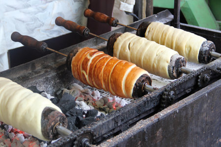 Trdelnik in Prague, traditional national Czech sweet street food. Trdlo is tubes of sweet dough, cooked on an open fire.の写真素材