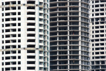 Unfinished concrete apartment building with repetitive window patternの写真素材