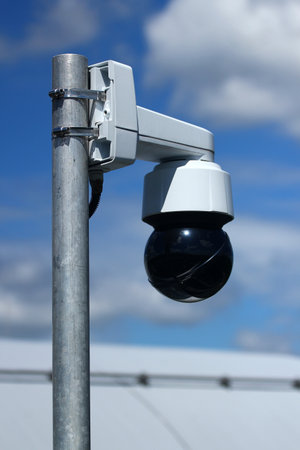 Outdoor dome surveillance camera mounted on metal poleの写真素材