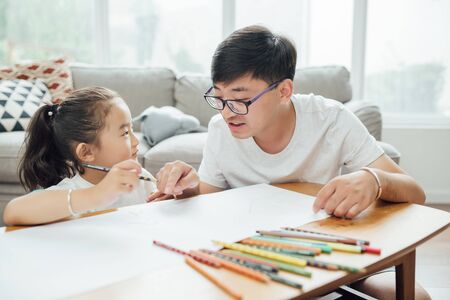 Young father is drawing and playing with the childの写真素材