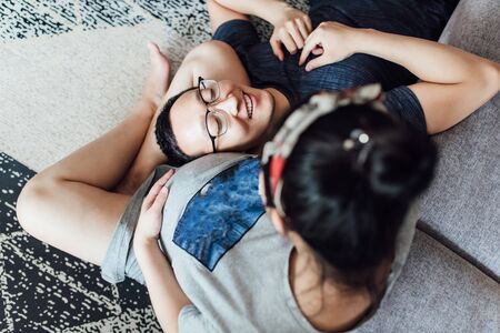 Young couple enjoying the upcoming newborn at homeの写真素材