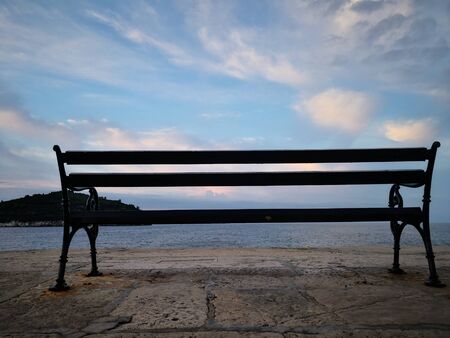 Dubrovnik, Croatia, photographing a lonely chair by the seaの写真素材