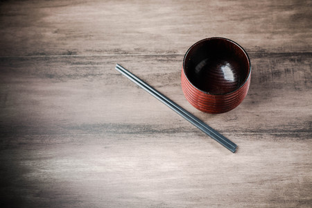 Wooden tea cup and chopsticks on the tableの写真素材