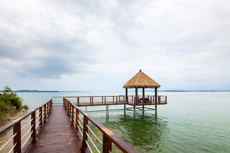 Wooden jetty over the beautiful  with blue skyの写真素材