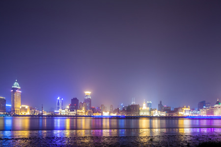 Shanghai historic architecture panorama at night lit by lights over Huangpu Riverの写真素材