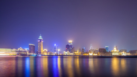 Shanghai historic architecture panorama at night lit by lights over Huangpu Riverの写真素材