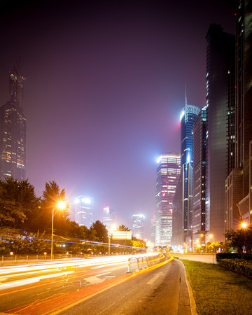 the light trails on the modern building background in shanghai china.の写真素材