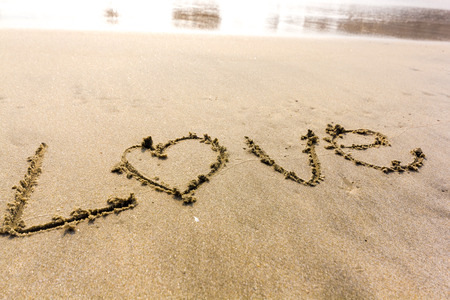 Word LOVE on sandの写真素材