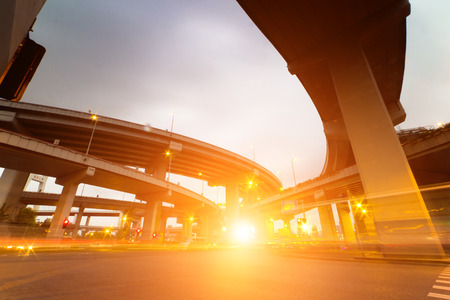 Freeway in night with cars light in modern city.の写真素材
