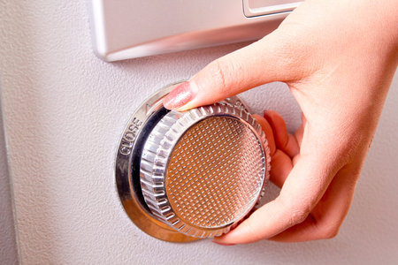 open the steel safe,finger turn it of a  womanの写真素材
