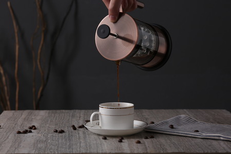 Coffee maker with coffee cup on deskの写真素材