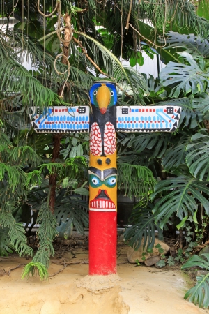 Totem poles and tropical plants in a gardenの写真素材
