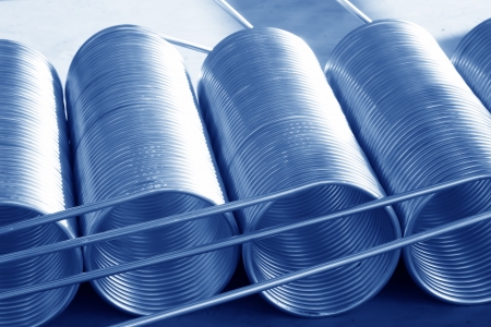 stacked copper spiral parts in a warehouse, in a manufacturing factoryの写真素材